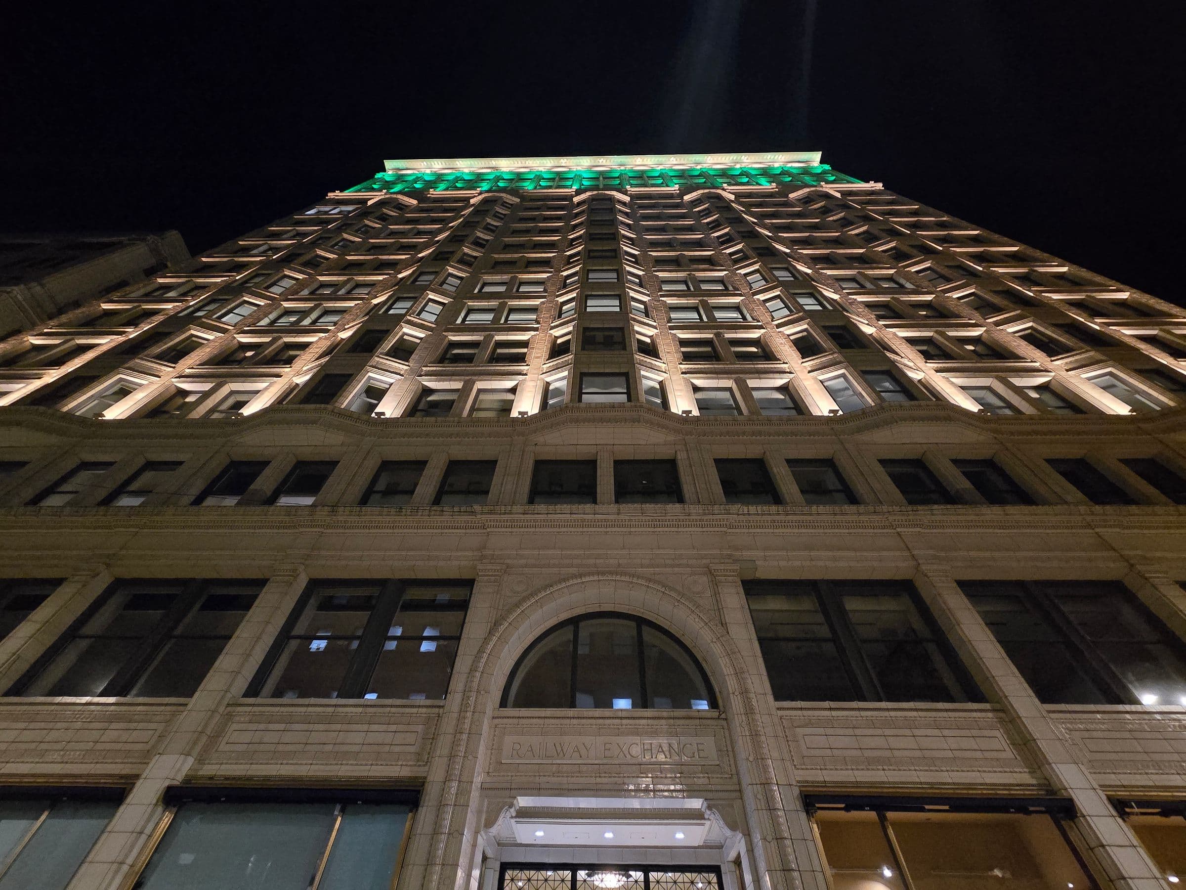 Looking up at the illuminated facade of a Chicago landmark